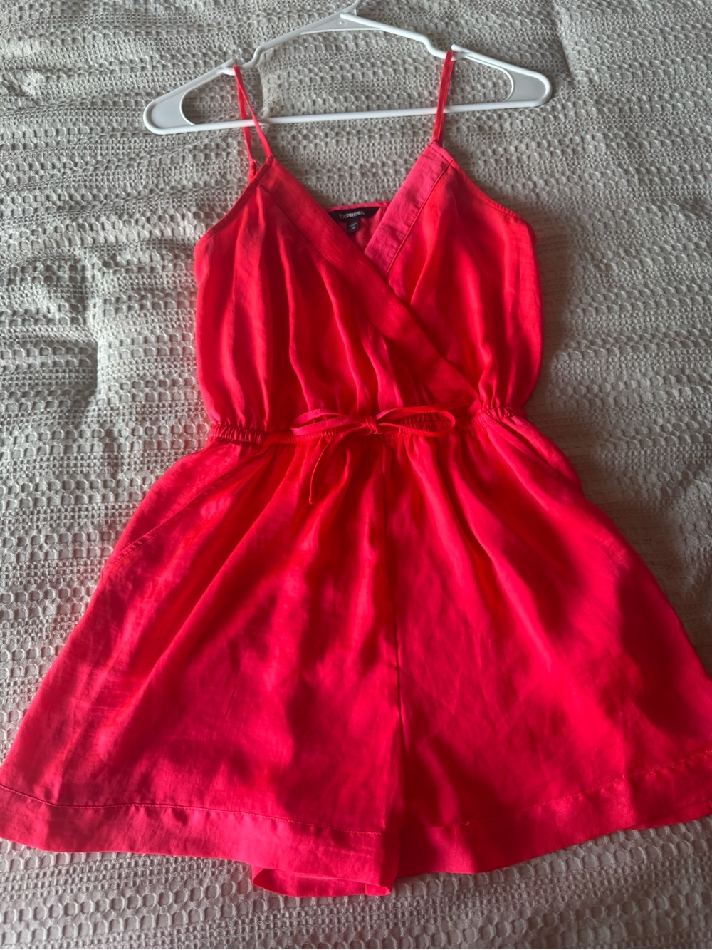 Hot pink silky romper with wrap tie waist and pockets. Perfect summer number!